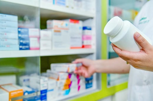 Pharmacist selecting medication